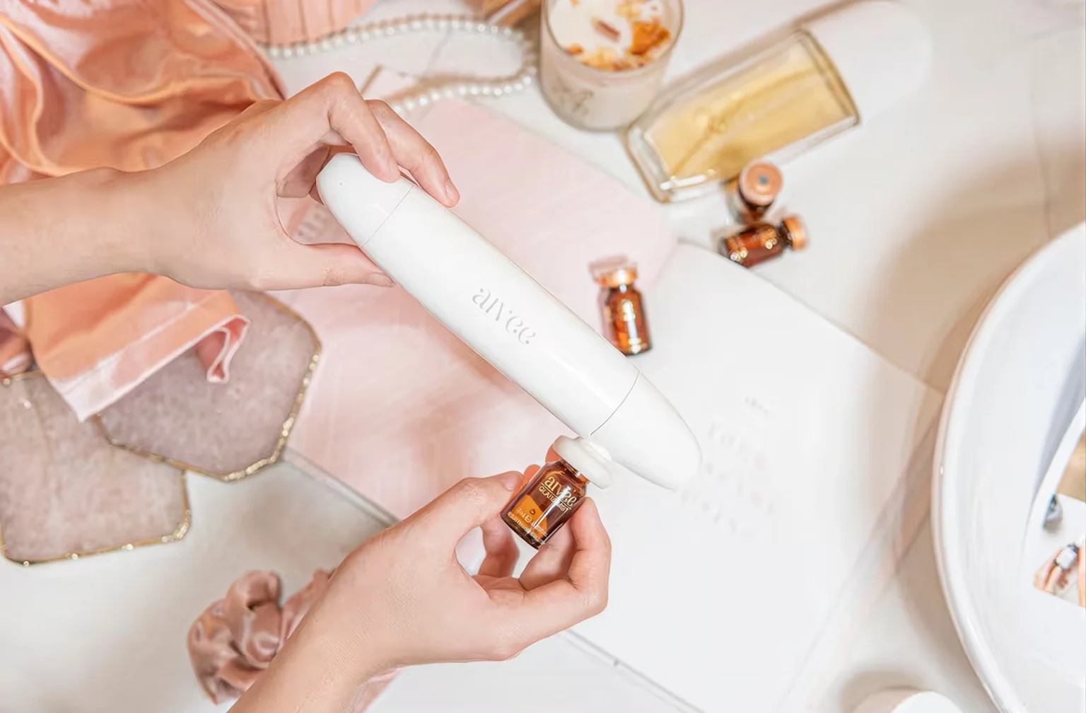 Aivee Glass device with Glass Mist brightening ampoules against a soft white backdrop