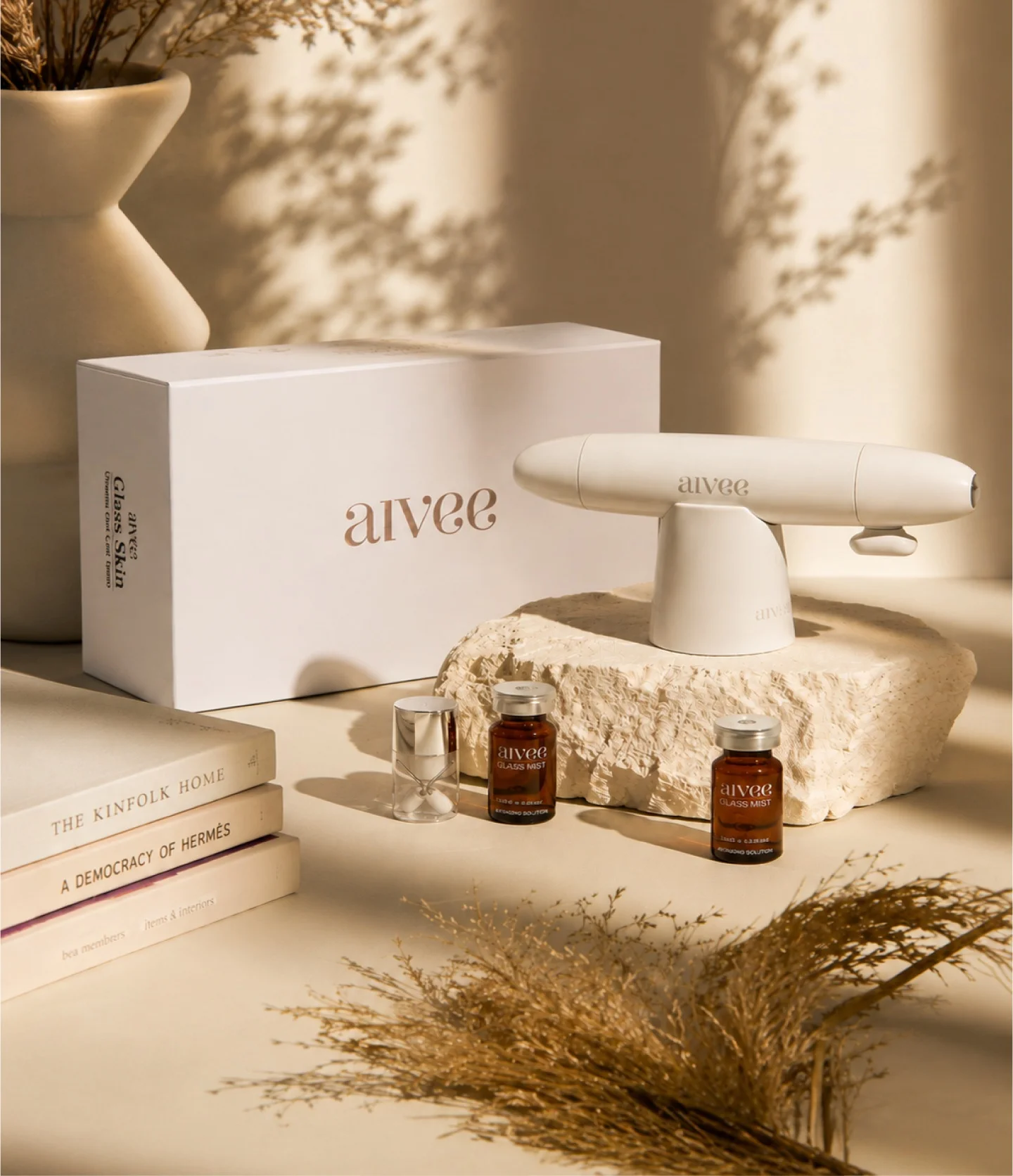 Aivee Glass anti-aging device and serum ampoules on a stone pedestal test